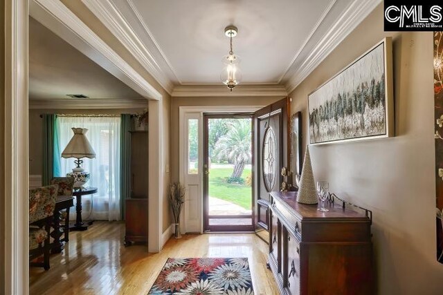 entrance foyer featuring light hardwood / wood-style floors and ornamental molding