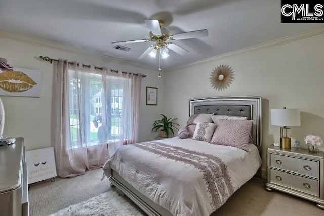 bedroom featuring carpet flooring, ornamental molding, and ceiling fan