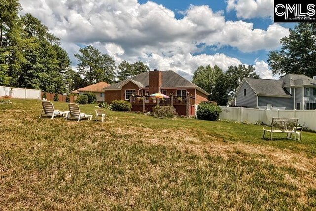 rear view of house with a yard