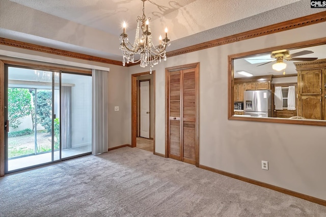 carpeted empty room with ceiling fan and a textured ceiling