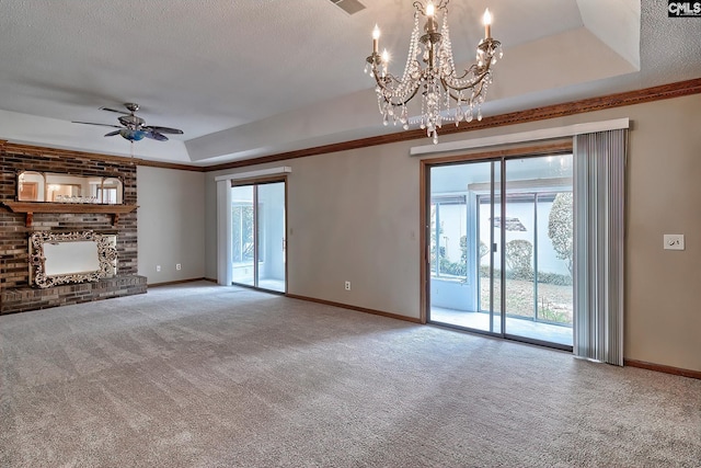 unfurnished living room with a brick fireplace, a textured ceiling, carpet flooring, a raised ceiling, and ceiling fan