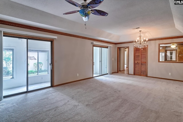 empty room with crown molding, carpet flooring, a textured ceiling, ceiling fan with notable chandelier, and a raised ceiling