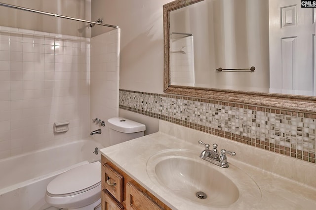 full bathroom with vanity, tiled shower / bath combo, and toilet