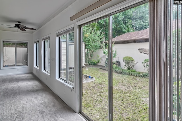 unfurnished sunroom with ceiling fan