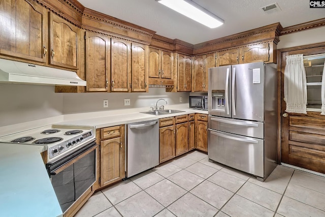 kitchen with sink, stainless steel appliances, and light tile patterned flooring