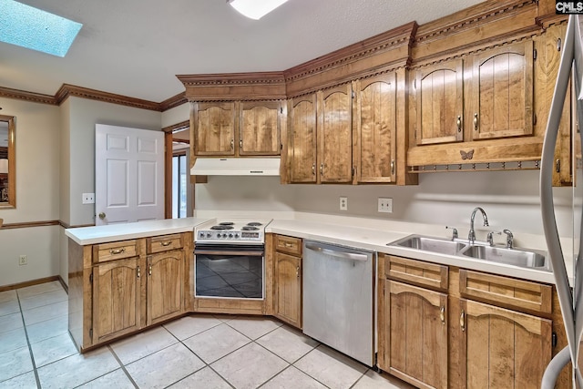 kitchen featuring a skylight, sink, light tile patterned floors, kitchen peninsula, and stainless steel appliances