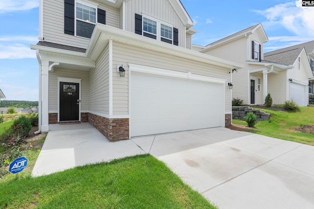 view of front of home featuring a garage and a front lawn