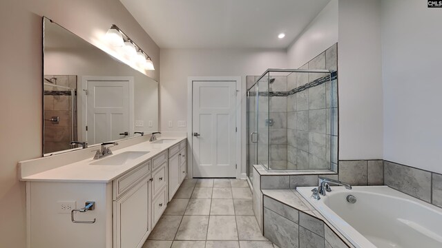 bathroom featuring tile patterned flooring, independent shower and bath, and double sink vanity