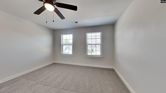 unfurnished room with ceiling fan and carpet flooring