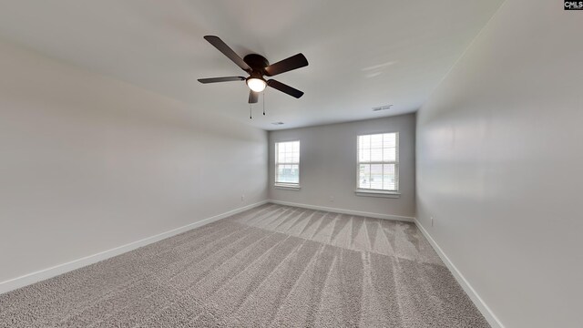 carpeted spare room featuring ceiling fan