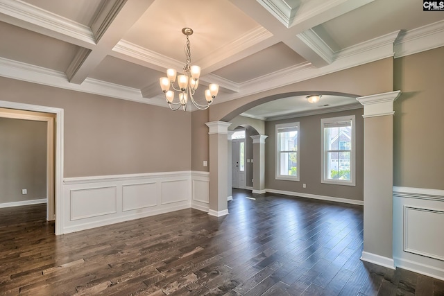 spare room with decorative columns, a chandelier, dark hardwood / wood-style flooring, and coffered ceiling