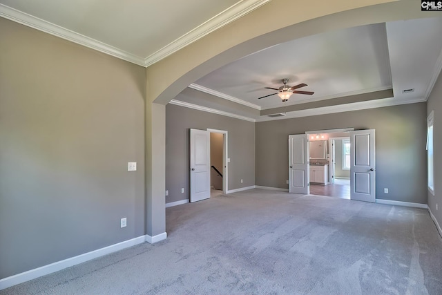 unfurnished bedroom with crown molding, carpet, ceiling fan, and a raised ceiling