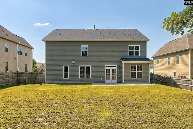 back of house with a lawn and a patio area