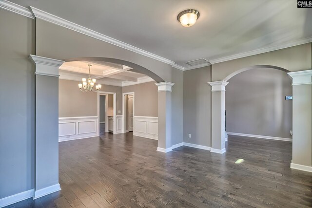 unfurnished room featuring dark hardwood / wood-style flooring, crown molding, an inviting chandelier, beam ceiling, and coffered ceiling