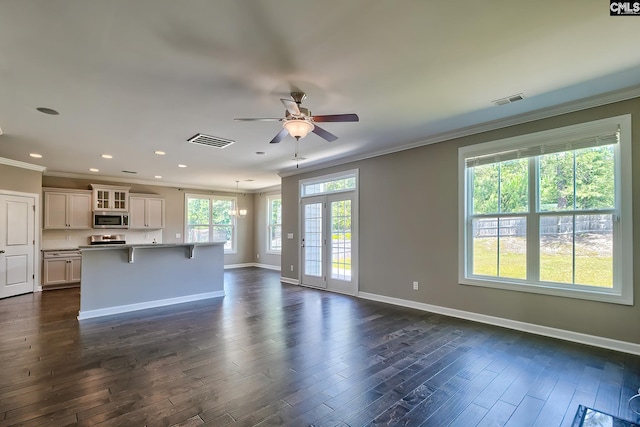 unfurnished living room featuring ceiling fan, dark wood-type flooring, and crown molding