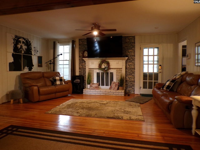 living room with a fireplace, hardwood / wood-style flooring, plenty of natural light, and ceiling fan