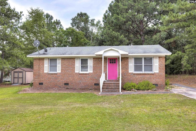 view of front of property featuring a front lawn and a shed