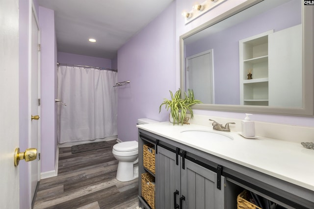 bathroom with vanity, wood-type flooring, toilet, and a shower with shower curtain