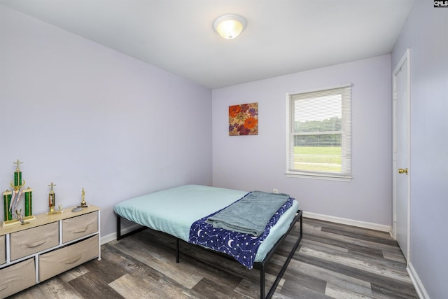 bedroom with dark hardwood / wood-style floors