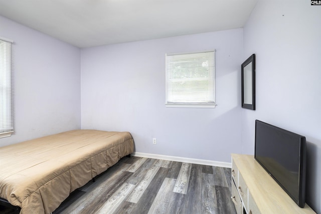 bedroom with dark hardwood / wood-style flooring