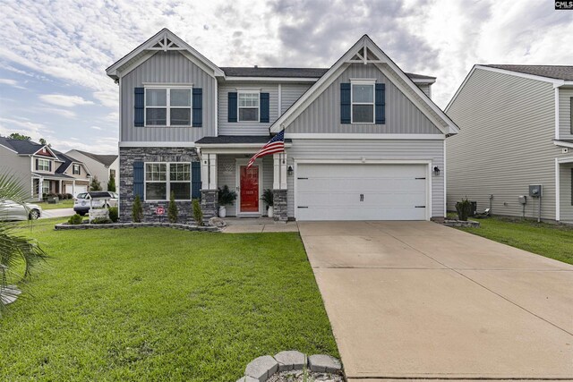 craftsman-style house featuring a garage and a front yard