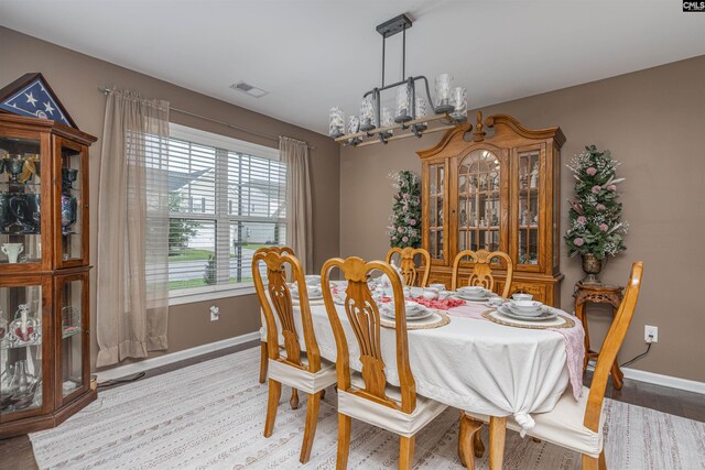 dining room with wood-type flooring