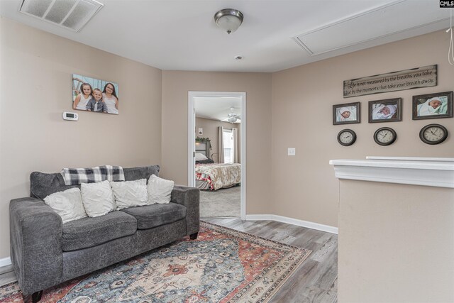 living room with ceiling fan and hardwood / wood-style flooring