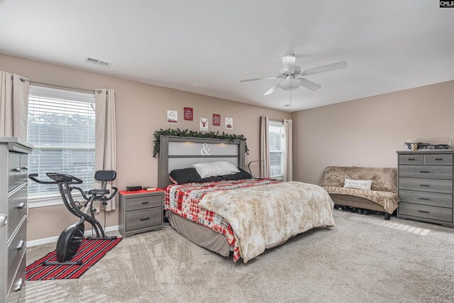 bedroom with carpet, multiple windows, and ceiling fan