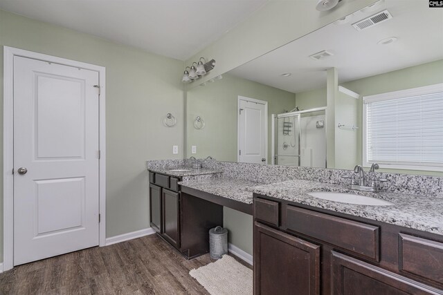 bathroom featuring dual vanity and hardwood / wood-style floors