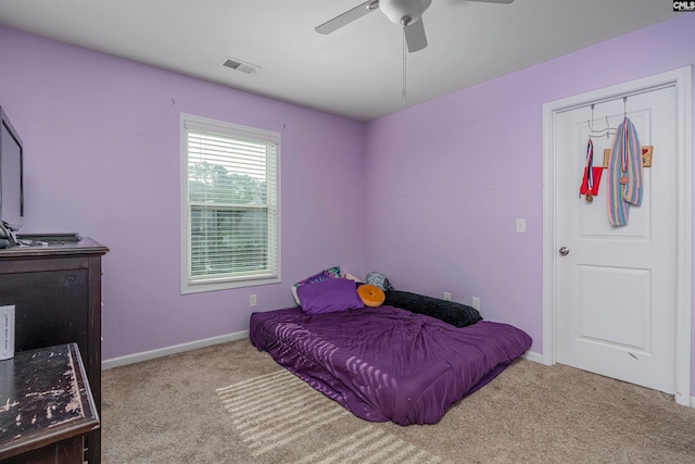 carpeted bedroom featuring a closet and ceiling fan