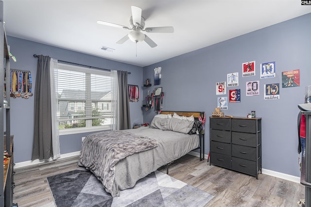 bedroom with ceiling fan and light hardwood / wood-style floors