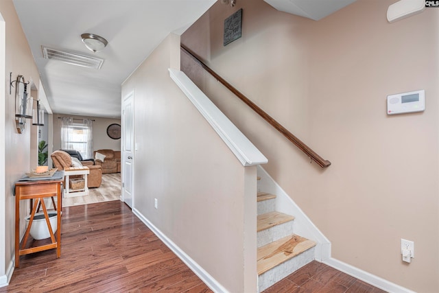 stairs with hardwood / wood-style flooring