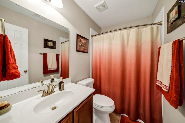 bathroom with vanity, tile patterned flooring, and toilet