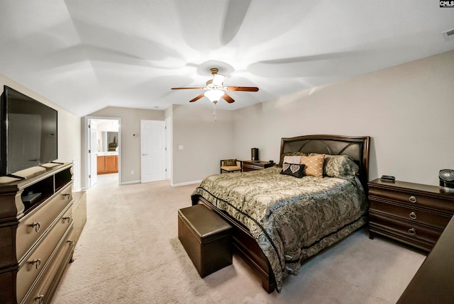 bedroom with light carpet, ensuite bathroom, ceiling fan, and vaulted ceiling