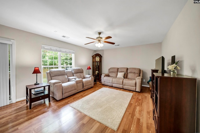 living room featuring light hardwood / wood-style flooring and ceiling fan