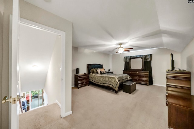 carpeted bedroom with ceiling fan and vaulted ceiling