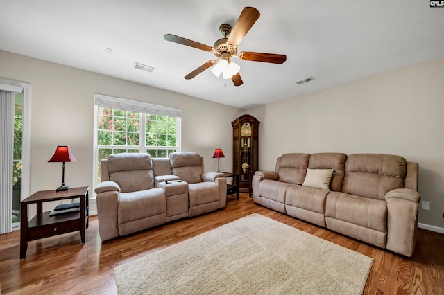 living room with light hardwood / wood-style floors and ceiling fan