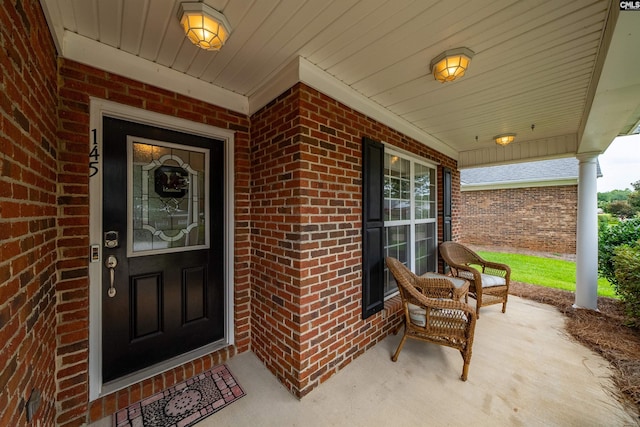 entrance to property featuring covered porch