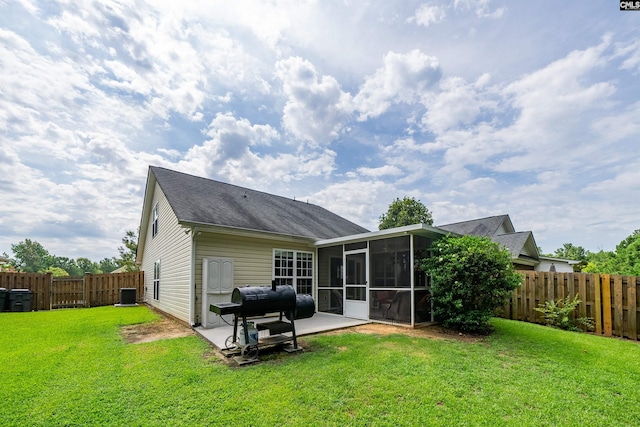 back of property featuring a patio area, a sunroom, and a yard