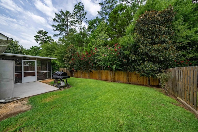 view of yard featuring a patio and a sunroom