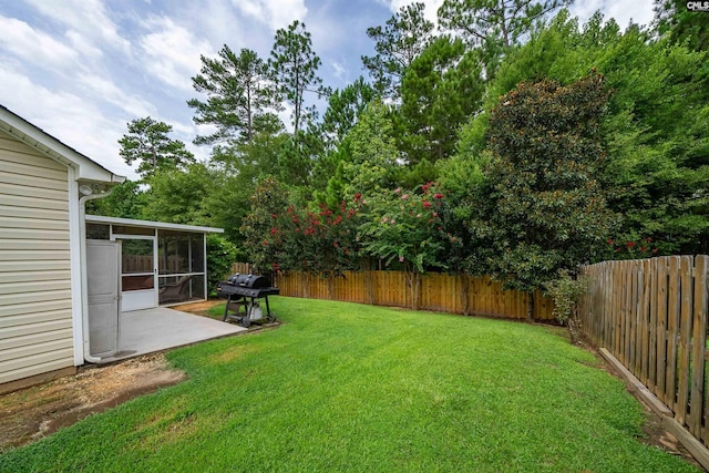 view of yard featuring a patio area and a sunroom