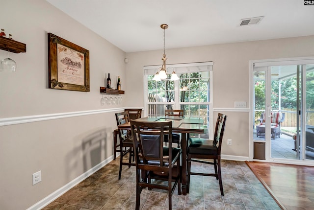 dining area featuring an inviting chandelier and tile patterned flooring