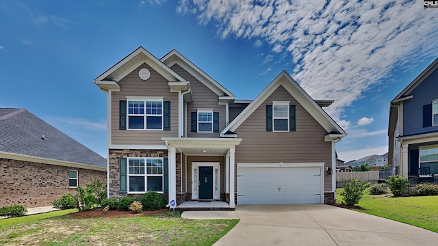 craftsman inspired home featuring a garage and a front yard