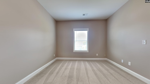 unfurnished room with light carpet