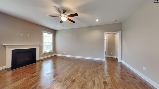 unfurnished living room featuring ceiling fan and light wood-type flooring