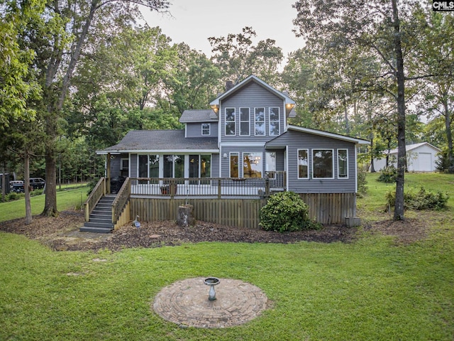 rear view of house with a yard and a deck