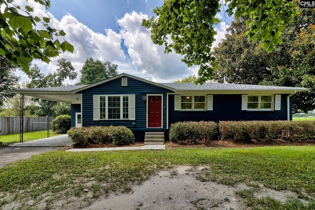 ranch-style house with a carport and a front lawn