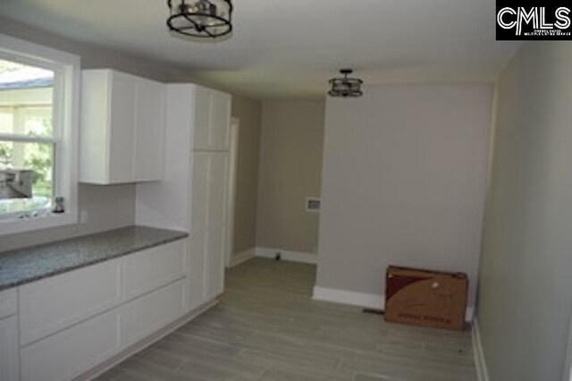 kitchen with dishwasher, sink, white cabinetry, light hardwood / wood-style floors, and range