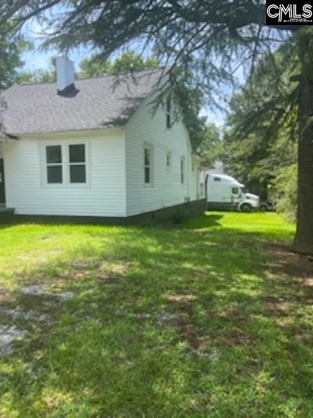 view of property exterior featuring a yard