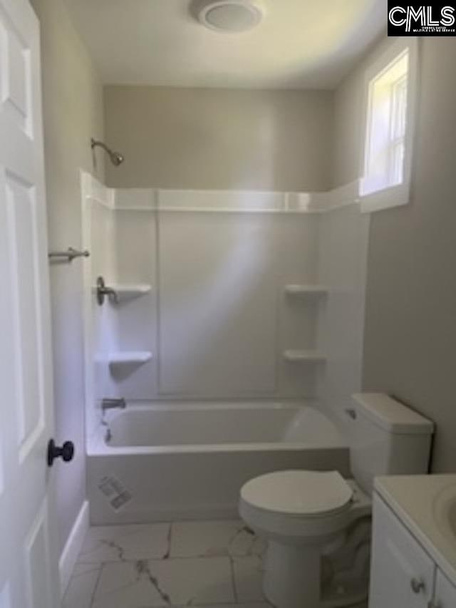 full bathroom featuring washtub / shower combination, toilet, vanity, and tile patterned flooring